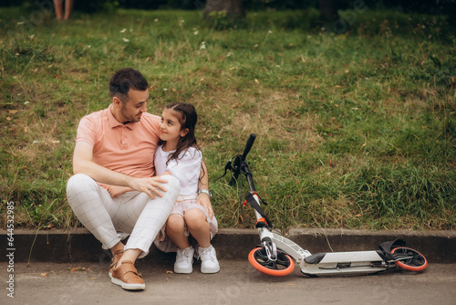 Dad and daughter ride an electric scooter on June 20, 2022 Moscow