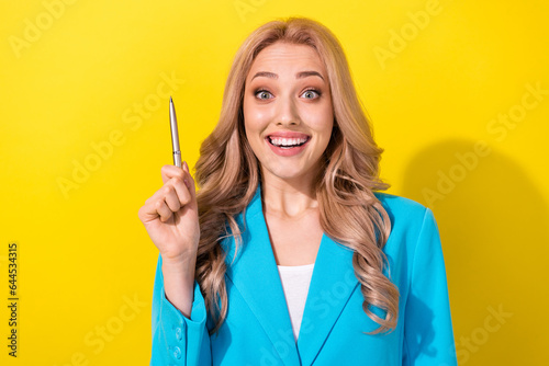 Photo of cheerful clever lady hand hold point pen toothy smile bright idea isolated on yellow color background