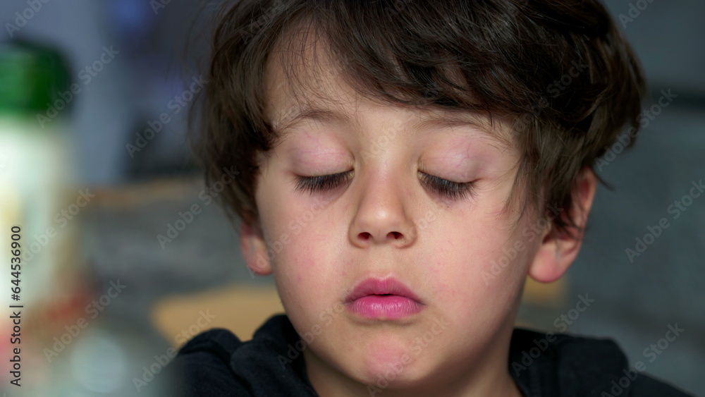 Youngster's Distanced Gaze and Evident Boredom, Rolling Eyes. bored kid with nothing to do, close-up face Youngster's Distanced Gaze and Evident Boredom, Rolling Eyes. bored kid with nothing to do, close-up face