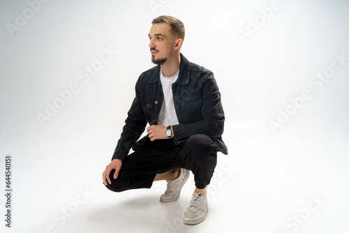 Young handsome guy on a gray studio background photo