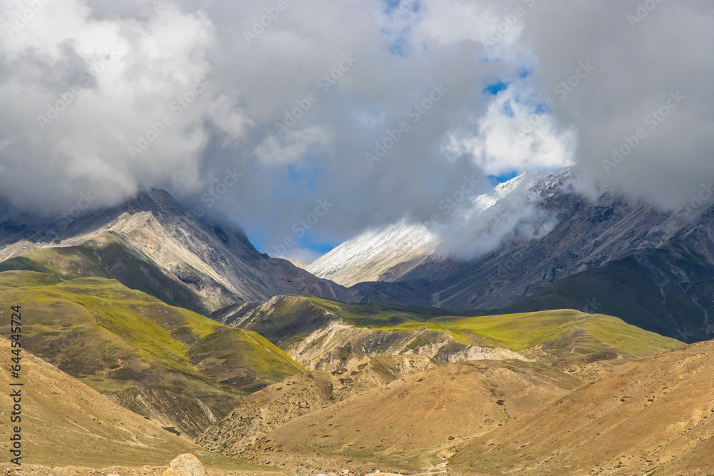 Dark Clouds HImalayan Mountains and Road to Korala Border between Tibet China and Upper Mustang, Nepal Dark Clouds HImalayan Mountains and Road to Korala Border between Tibet China and Upper Mustang, Nepal