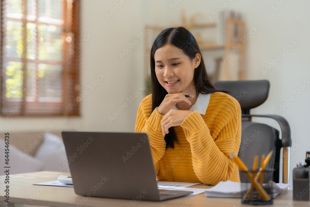 Beautiful young Asian woman student studying online with laptop computer at home. Asian woman work and using laptop at home. Beautiful young Asian woman student studying online with laptop computer at home. Asian woman work and using laptop at home.