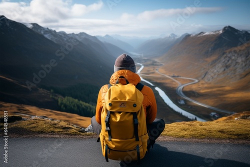 A traveler explores picturesque mountain landscapes with a yellow backpack