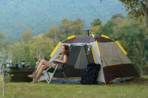 An Asian woman camper relaxing and enjoying camping alone.