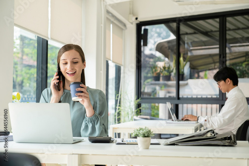 Businesswoman working with laptop and drinking coffee.