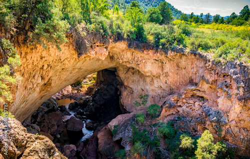 People stand near the river running through Tonto Natural Bridge in Payson Arizona