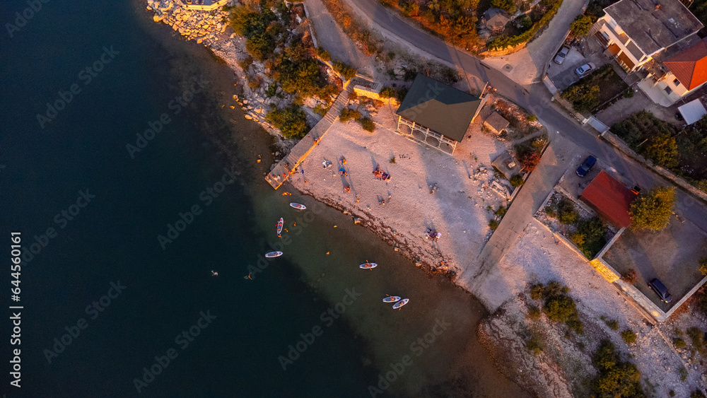 Aerial drone view of a Shiroka lake beach at sunset near Shkoder. Albania