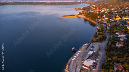Aerial drone view of Shiroka Lake at sunset and its restaurant area near Shkoder. Albania