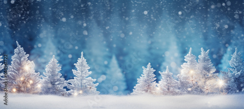 winter blurred background. Xmas tree with snow decorated with garland lights, holiday festive background. Widescreen backdrop