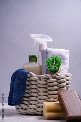 Brushes, sponges, rubber gloves and natural cleaning products in the basket. Eco-friendly cleaning products