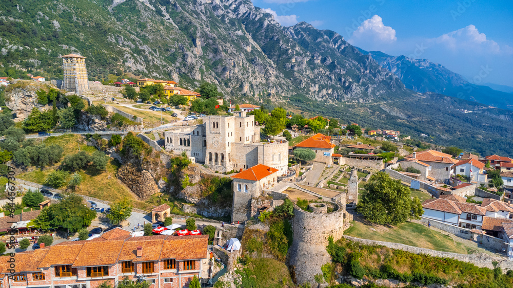 The beautiful Kruje Castle and its fortress seen from an aerial drone view, tower and the Kruje museum with the mountains in the background. Albania