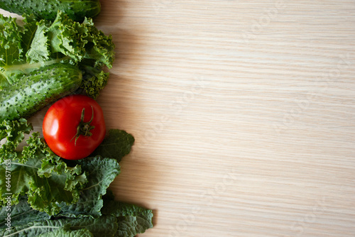 Fresh vegetables on wood background. Aromatic herbs  corn  cucumber  tomatoes  kale  leaf cabbage