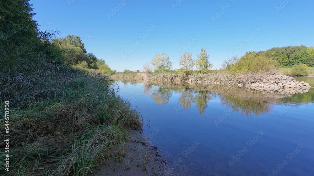 Groyne fields on the blue Danube with overgrown banks in an idyllic landscape in Bavaria Groyne fields on the blue Danube with overgrown banks in an idyllic landscape in Bavaria