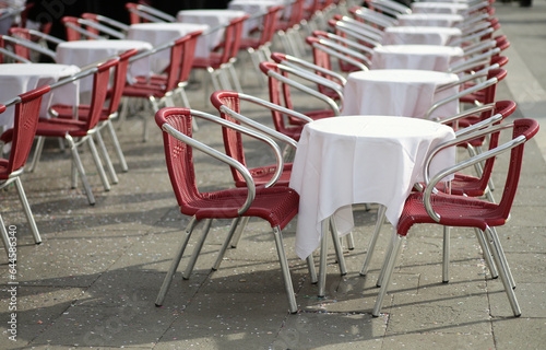r table with white tablecloth and empty chairs waiting for customers