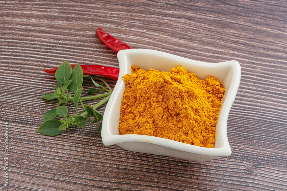 Yellow vibrant curcuma powder in the bowl Yellow vibrant curcuma powder in the bowl