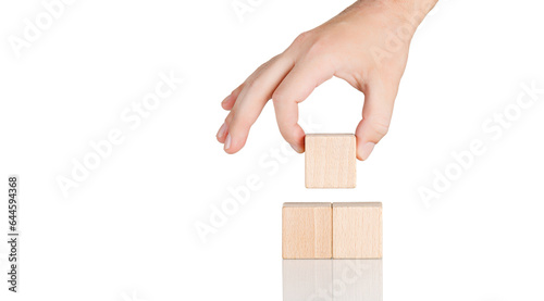 wooden cubes in the form of a pyramid with a hand on an isolate white background