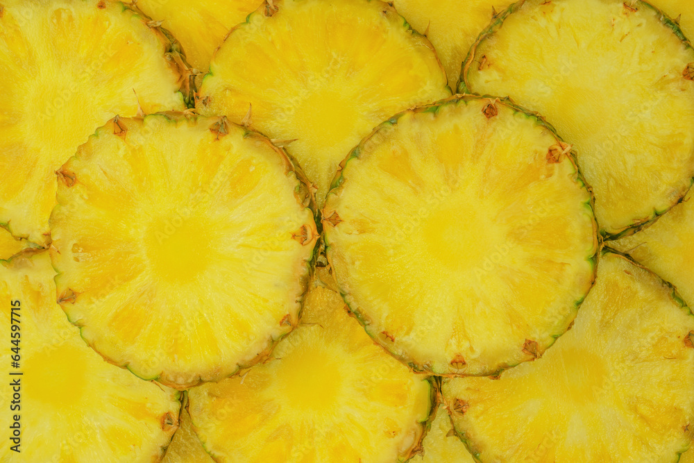 Pineapple juicy yellow slices as a background. Pineapple juicy yellow slices as a background.