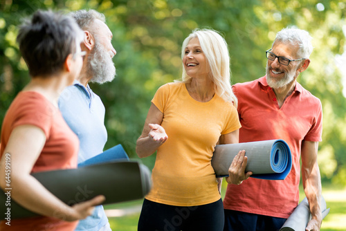 Group of happy senior people talking to each other after exercising outdoors