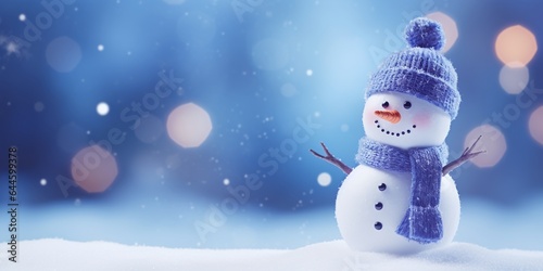 Fototapeta Christmas winter background with snowman in snow and blurred bokeh background