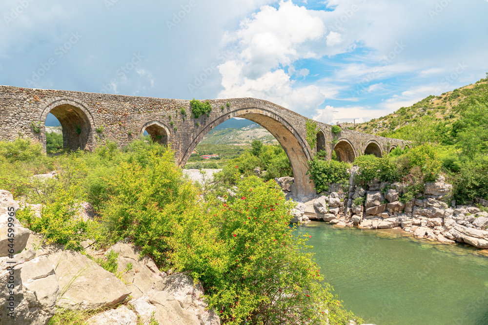 Mesi Bridge in Albania is stunning example of architectural brilliance across the Kir River in the charming village of Mesi. This stone bridge has a rich history, dating back to time of Ottoman Empire