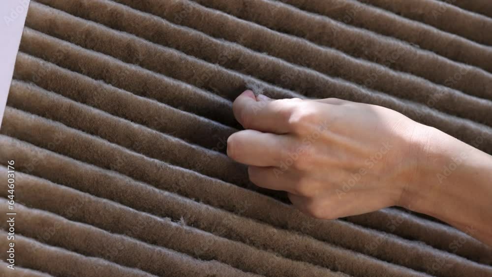 Hands pick up dust from dirty and clogged house AC filter. Concept of air quality inside home and the need to replace old filters