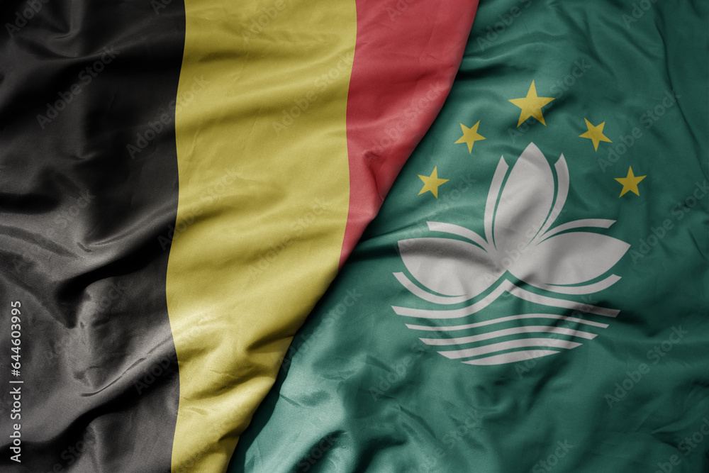 big waving national colorful flag of belgium and national flag of Macau . big waving national colorful flag of belgium and national flag of Macau .