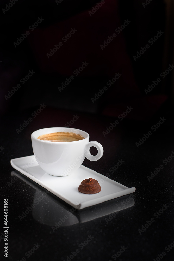 cup of americano with chocolate candy