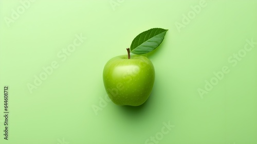 Single green apple on a minimal green background.