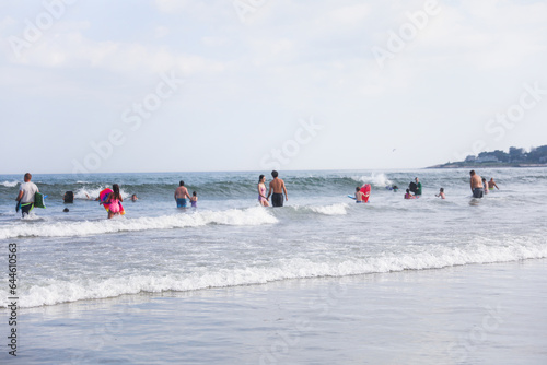 beach scene captures the essence of a scorching summer day, where people revel in the refreshing waters, laughter, and endless fun under the blazing sun © Your Hand Please