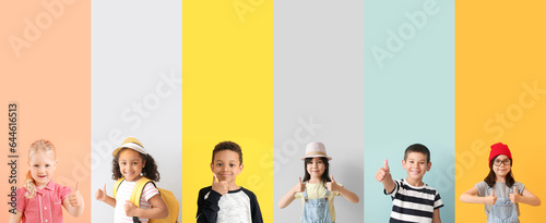 Collage of happy little children showing thumb-up gesture on color background