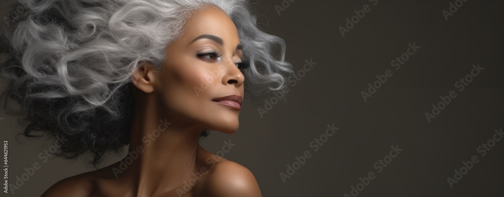 In a portrait of fashion and beauty, a woman with wild grey hair cascading in ringlets and eyelashes painted with lipstick stands out in a bold statement of style and grace