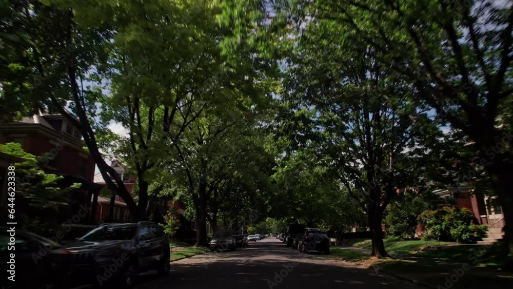 Car driver point of view POV driving through German Village suburban neighborhood streets, with lots of houses, trees, sidewalks, and historic buildings outside Columbus, Ohio on a summer afternoon Car driver point of view POV driving through German Village suburban neighborhood streets, with lots of houses, trees, sidewalks, and historic buildings outside Columbus, Ohio on a summer afternoon