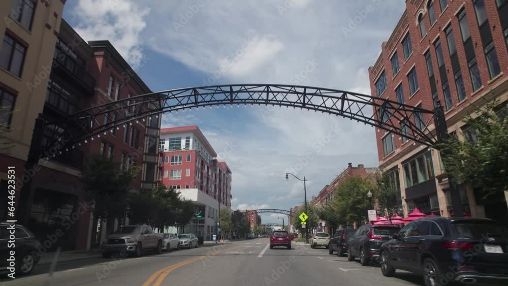 Columbus, Ohio  United States - September 6 2023: Car driver point of view moving north up High Street through Short North Arches by Columbus, Ohio with traffic, bars, art galleries, and restaurants