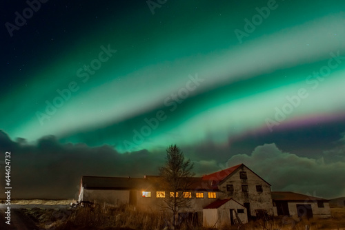 Northern Light, spectacular Aurora borealis over a farm in Iceland