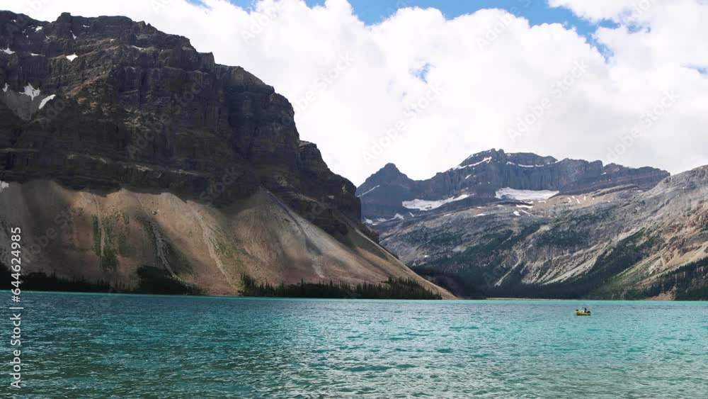 Views of the bright blue Bow Lake with surrounding mountains and forests in Banff National Park, Alberta, Canada. Glacial lake in the Canadian Rockies. Views of the bright blue Bow Lake with surrounding mountains and forests in Banff National Park, Alberta, Canada. Glacial lake in the Canadian Rockies.