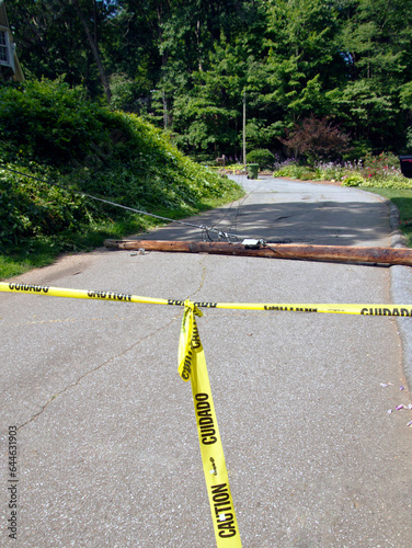 Telephone Pole Lies Across Road Marked With Yellow Tape