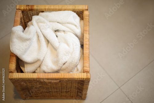Dirty cloth towels in wooden box in bathroom, household chore © Olga