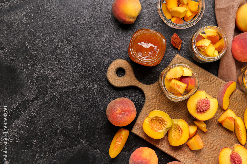 Jars with sweet peach jam and fresh fruits on black background