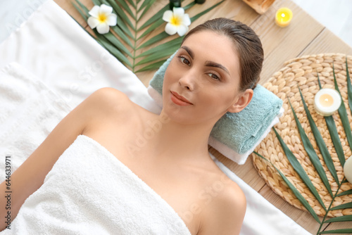 Young woman relaxing in spa salon, top view