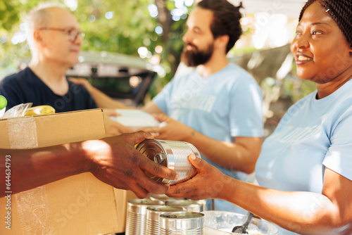 Photography Multiethnic volunteers in a charitable event, handing out food to the poor and needy