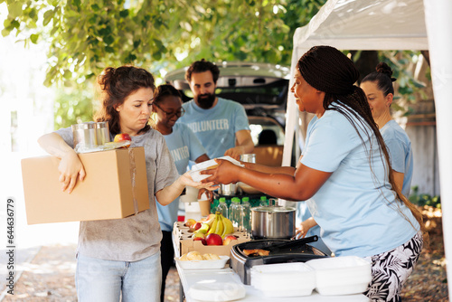 Diverse group of volunteers happily distributing food to the needy. Smiles and genuine happiness all around as they provide donations to homeless individuals and seniors facing poverty.