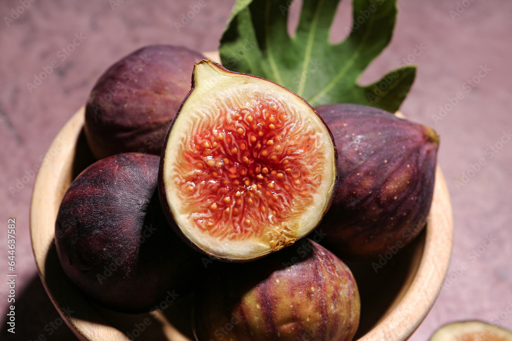 Bowl with fresh ripe figs on pink background Bowl with fresh ripe figs on pink background