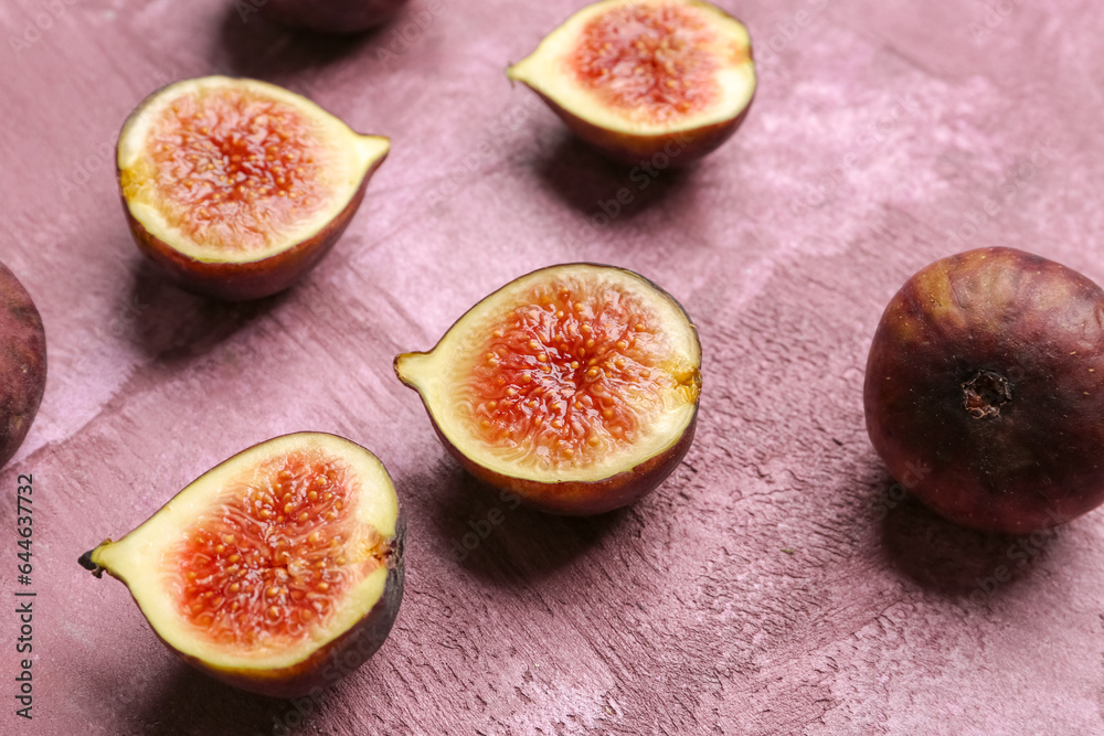 Halves of fresh ripe figs on purple background Halves of fresh ripe figs on purple background