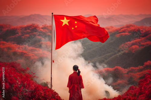 Back view of a Chinese woman with a Chinese flag on the mountain.  © Alan