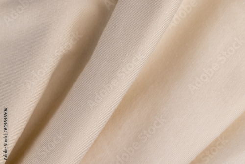 details of a piece of clothing sewn from soft beige cotton fabric