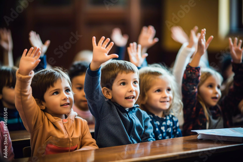 Young children at their desks in the classroom raising their hands primary education teaching and interaction school concept selective focus