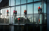 Workers washing windows in the office building