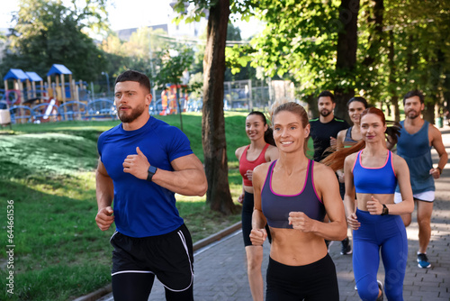 Fototapeta Naklejka Na Ścianę i Meble -  Group of people running in park. Active lifestyle