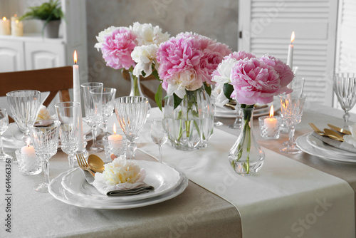 Fototapeta Naklejka Na Ścianę i Meble -  Stylish table setting with beautiful peonies and burning candles indoors