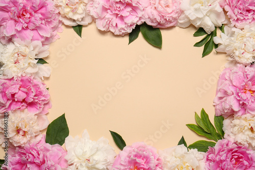 Frame made of beautiful peony flowers and green leaves on beige background, flat lay. Space for text